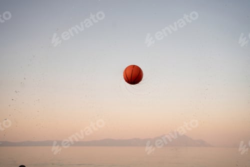 Preview: Family enjoying a sunset beach day with a vibrant basketball game