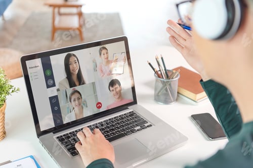 Preview: Asian businessman wear headphones working remotely from home and virtual video conference meeting