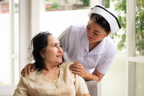 Vista previa: Beautiful nurse comforting female patient in the room.