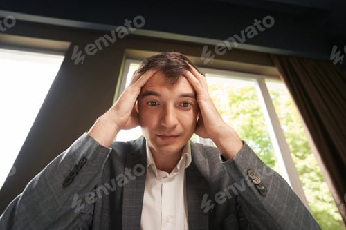 Preview: Clerical worker holding his head in dismay from work