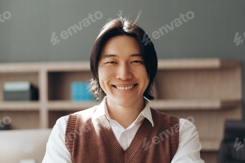 Preview: Smiling asian businessman is posing in his office