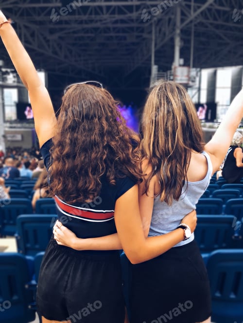 Preview: Two teenage girls watching a live concert