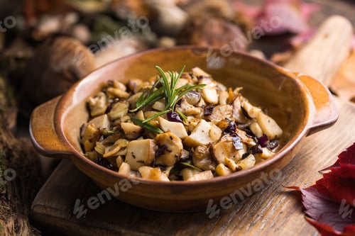 Preview: Fried forest mushrooms, boletus, onions. Rustic dish in a frying pan
