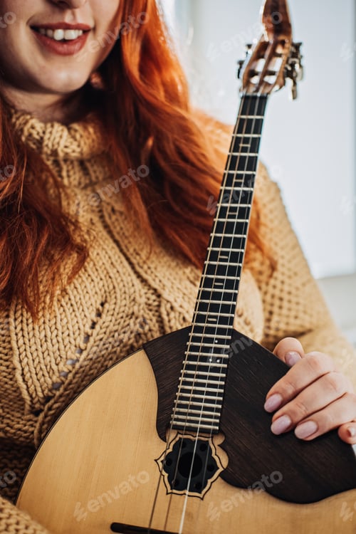 Preview: Domra Folk Musical Instrument in womans hand. Female hands with 4 strings Natural Wood Handmade