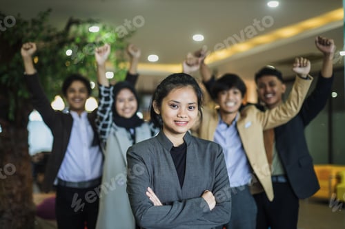 Preview: Portrait of young woman in business suit is smiling