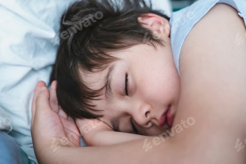 Preview: kid deep sleep in bed in the morning, Child sleeping on bed. Little boy taking a peaceful nap
