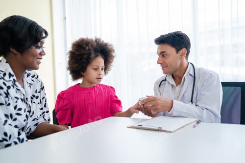 Preview: Hospitalized children sitting while doctor checking his pulse.