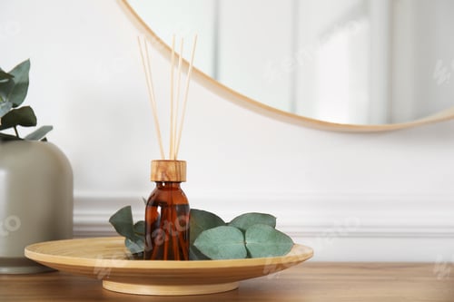 Preview: Reed diffuser and home decor on wooden table near white wall