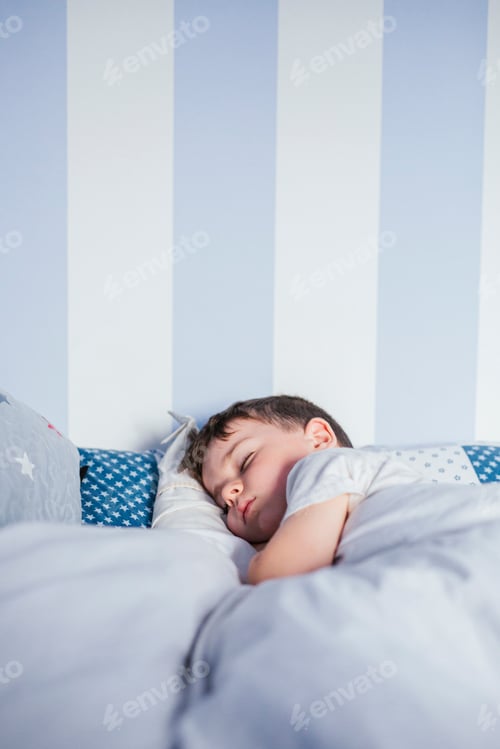 Preview: Little boy sleeping on bed in the morning