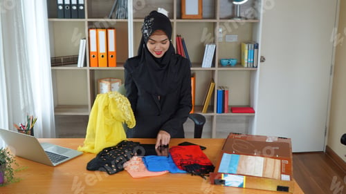 Preview: young pretty Muslim woman in hijab working on online shopping in her office room, shopping concept.