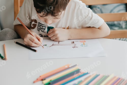 Preview: The boy draws with pencils at the kitchen