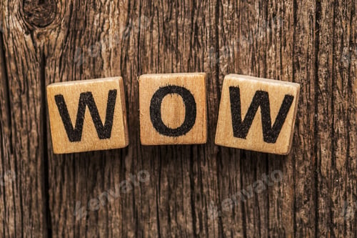 Wooden Blocks Spelling WOW on Wooden Background