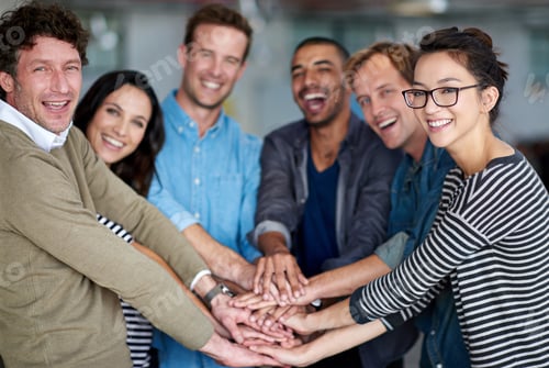 Preview: What a team. Portrait of happy group of coworkers holding their hands together in unity.