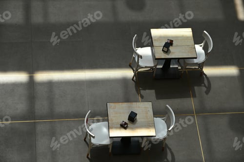 Preview: High angle shot of tables and emp chairs in a cafe