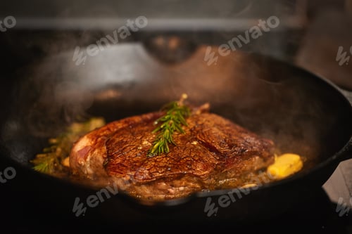Preview: This is guaranteed to be tasty. Shot of a piece of steak bring cooked.