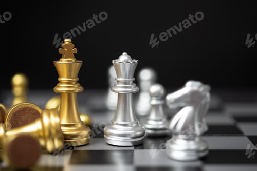 Preview: Strategy and business planning ideas. Chess golden king faces the silver queen on the board.