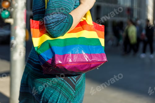 Preview: Person in blue dress hanging a rainbow bag
