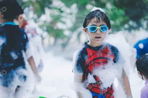 Preview: Children having fun at a foam party. child in foam enthusiastic joyful child at a foam party,