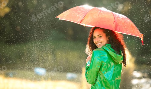 Preview: Shot of a beautiful young woman spending a day outside in the rain