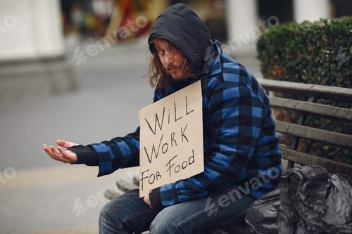 Preview: Homeless man in a durty clothes autumn city