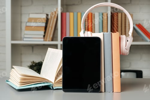 Preview: Digital tablet with stacked books in library