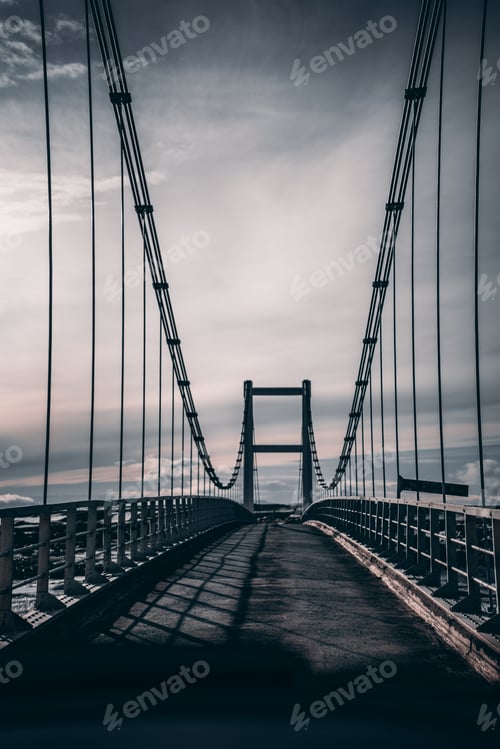 Preview: Moody empty suspension bridge view in barren landscape Iceland