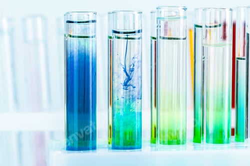 Preview: Different laboratory glassware with colored liquids close up