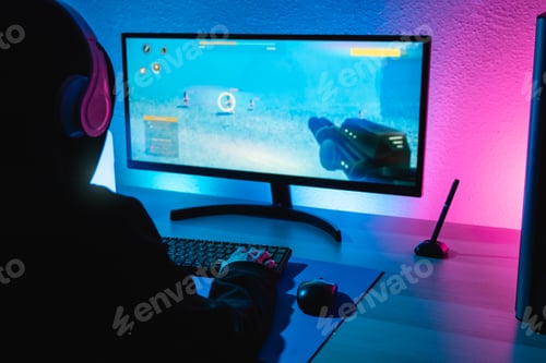 Preview: Girl playing shooter online video game - Technology trend concept - Focus on right hand