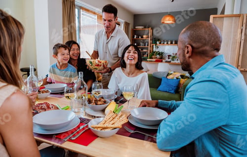 Preview: Family and friends reunion at home. Diverse family gathering enjoying dinner at home