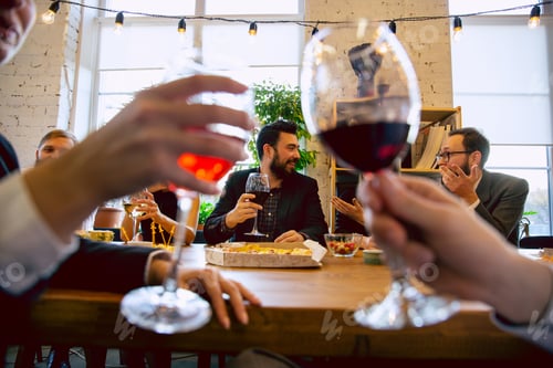 Preview: Happy co-workers celebrating while company party and corporate event