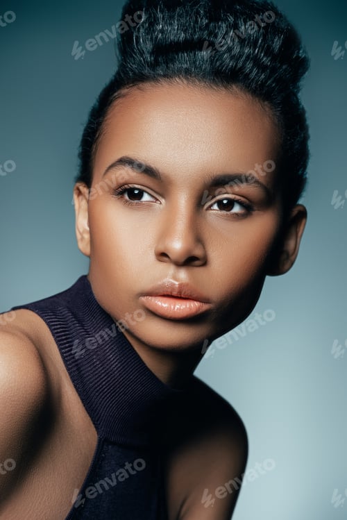 Preview: beautiful african american woman posing for fashion shoot, isolated on blue