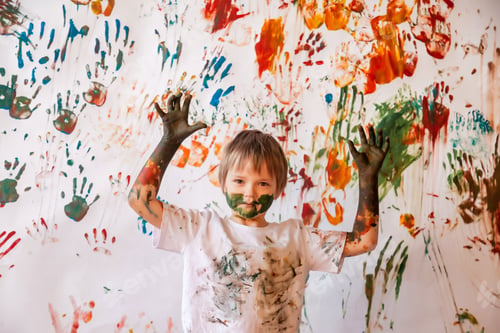 Preview: Portrait of happy young child playing with watercolor