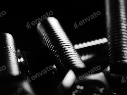 Preview: Closeup shot of metal screw threads isolated on the black background