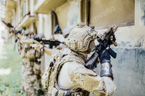 Preview: Soldier in full US MARSOC armed with assault rifle run through the abandoned building. Military