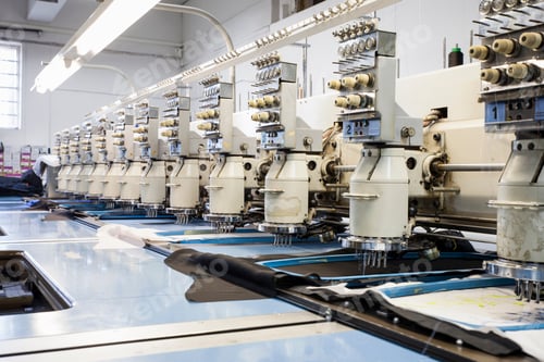 Preview: Rows of programmed embroidery machines speed stitching in clothing factory