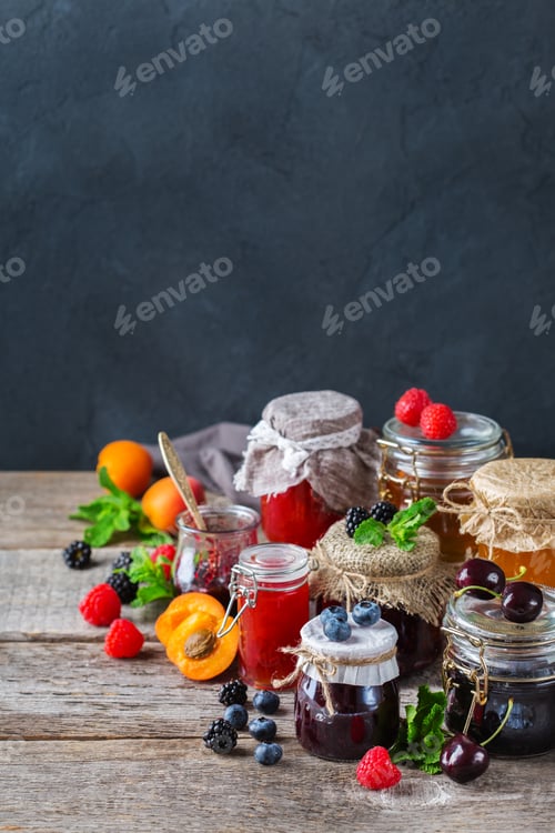 Preview: Assortment of seasonal berries and fruits jams in jars