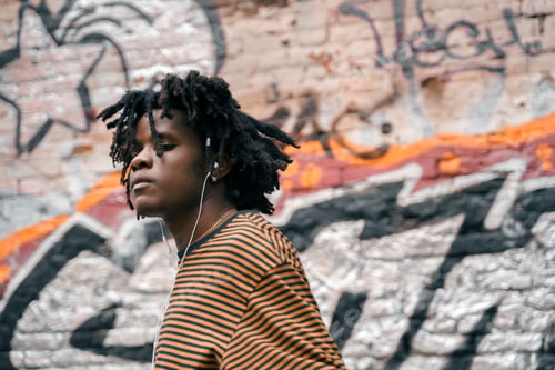 Preview: Portrait of young handsome dancing stylish black man with natural hair afro dreadlocks. Afroamerican