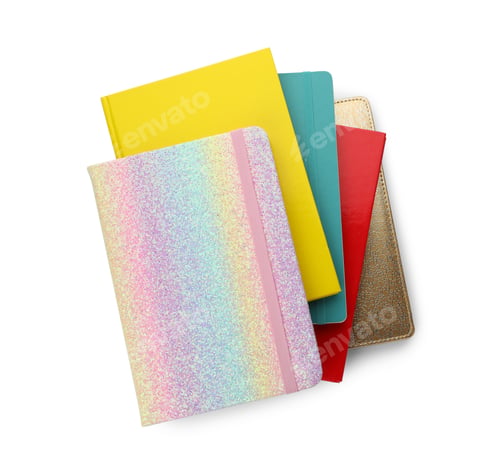 Preview: Stack of different colorful hardcover planners on white background, top view