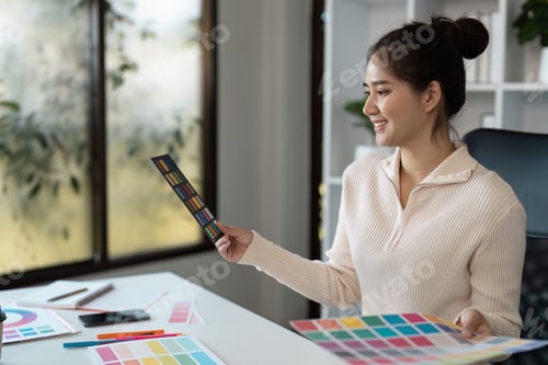Preview: Creative Graphic Designer Working with Color Palettes in Modern Office Environment