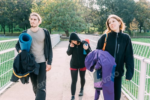 Preview: Three sportive friends walking outdoor