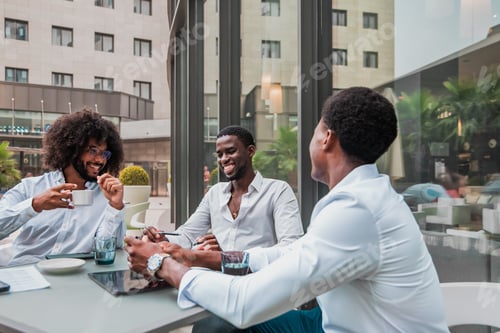 Preview: smiling african american coworkers at the business meeting exchanging ideas in a coffee shop