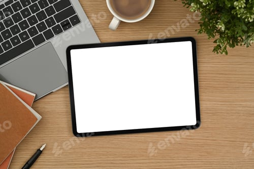 Preview: Digital tablet with white empty screen, laptop, notepad and coffee cup on wooden desk.