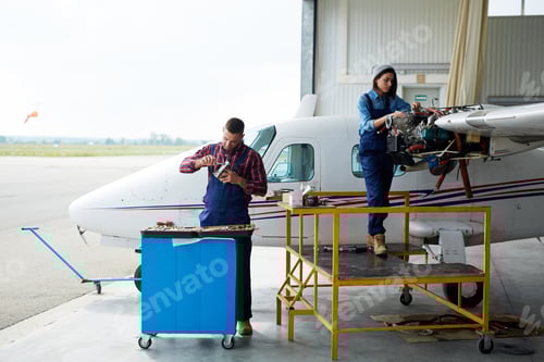 Preview: Engineers repairing airplane