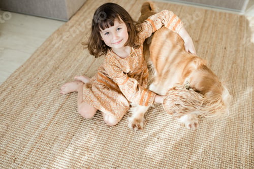 Preview: Happy child with pet at home living room
