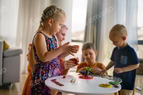 Preview: Children Playing with Modeling Clay at a Table