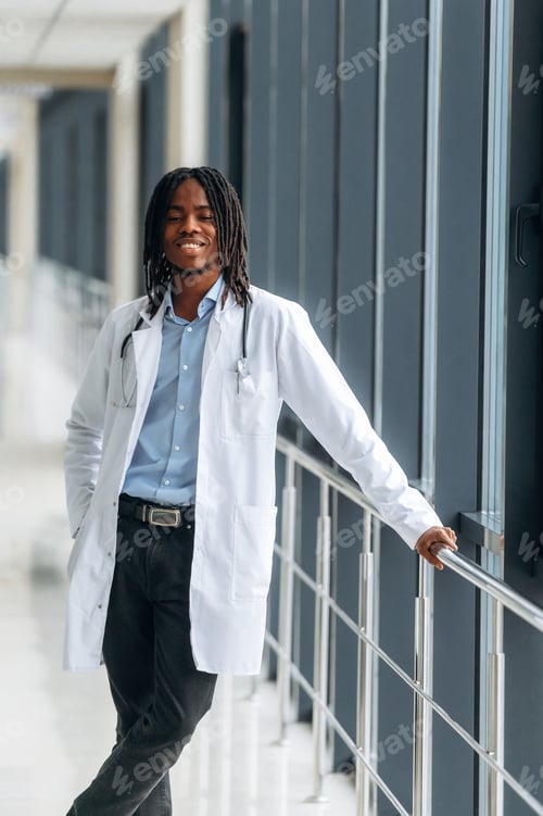 Preview: Smiling Doctor Stands in Hospital Hallway