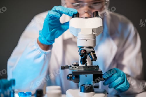Preview: Asian female scientist looking under microscope, analyzes petri dish sample. specialists working