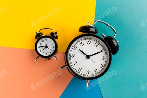 Preview: Vintage black alarm clock on a color block background