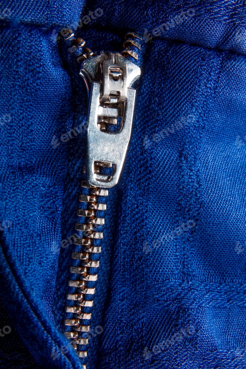 Preview: Fragment of blue jacket with metal zipper. ziplock background. Close up.