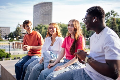 Preview: Group of diverse young adults enjoying a sunny day outdoors
